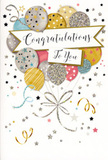 In this photograph, a stylish congratulations card stands upright, its front a rich tapestry of balloons and festive flourishes that evoke the cheerful character of Anerley. The central focus is a cluster of rounded balloons, grouped together so they appear to drift slowly upward, as if rising above the nearby rooftops and trees. Their colours blend harmoniously: warm tones of gold and champagne sit alongside cool silvers, washed sky blues, soft blush pinks, and gentle greys. Each balloon carries its own decorative touch-sparkling star patterns, fine stripes, or softly shimmering glitter that suggests a metallic finish catching the light, like evening sun over Betts Park. Slim, elegant strings flow from the balloons in gold and silver lines, curling and looping across the lower portion of the card with easy, natural movement. Surrounding the main cluster, the pale, understated background is animated by scattered stars, tiny confetti specks, and swirling ribbon motifs, giving an impression of air alive with celebration. Across the midsection, a softly unfurled banner holds the words Congratulations To You, written in graceful, cursive lettering that feels personal and warm, as though penned with care before being delivered alongside fresh blooms by Florist Anerley. The overall impression is one of joyful sophistication-light, airy, and full of quiet sparkle. This card suits many moments: an exam success, a promotion, a new home, or any achievement that deserves to be marked with tenderness and pride, then displayed on a shelf or mantel as a reminder of a happy day in Anerley.